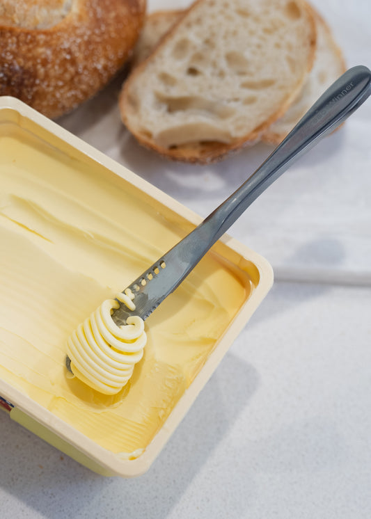 butter curls on the knife over the block