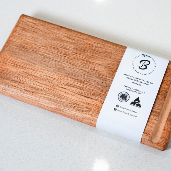 Handmade timber bread board on kitchen countertop.