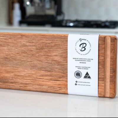 Handcrafted wooden bread board on kitchen countertop.